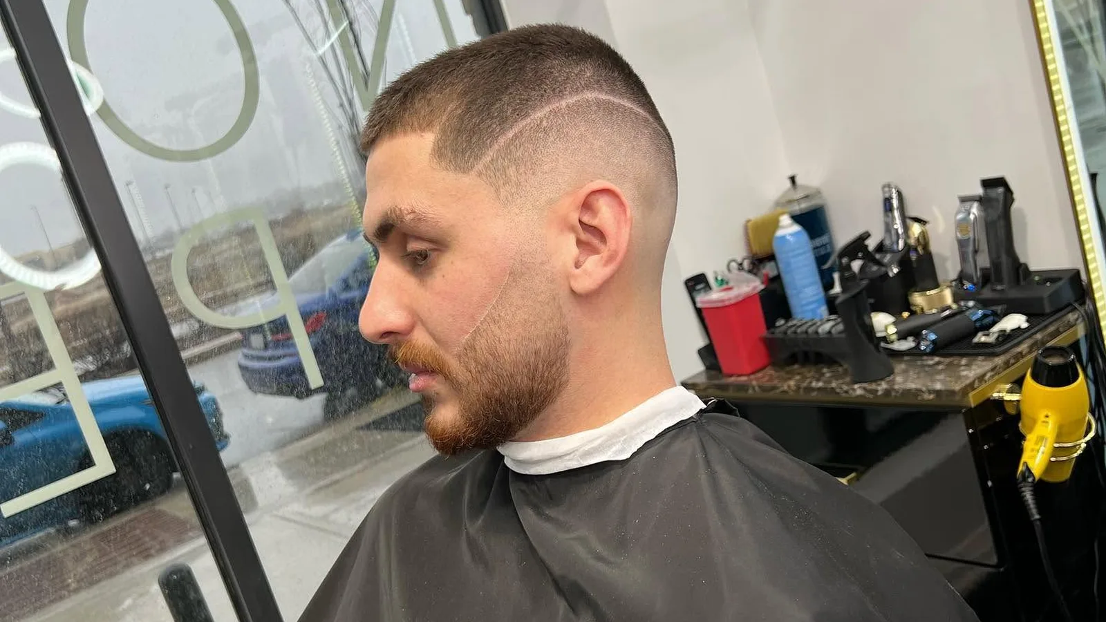Barber performing beard grooming on a client in Oakville