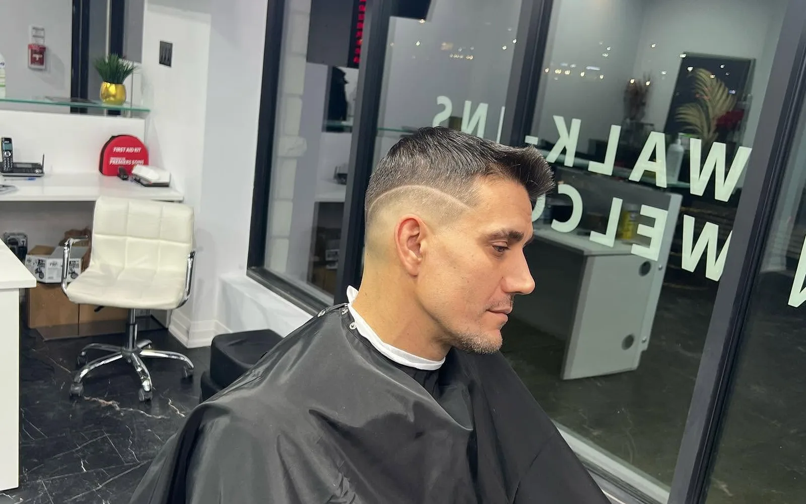 Finished haircut by the S Blends window with walk-ins welcome sign