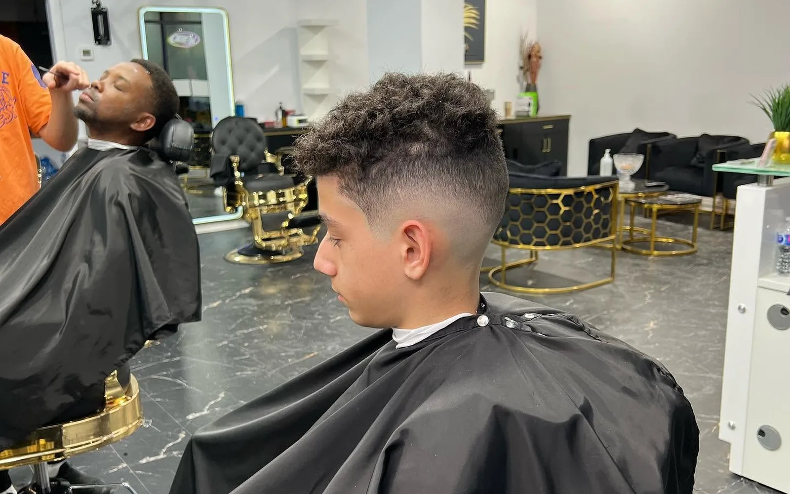 Young man with a curly top haircut and clean sides at S Blends